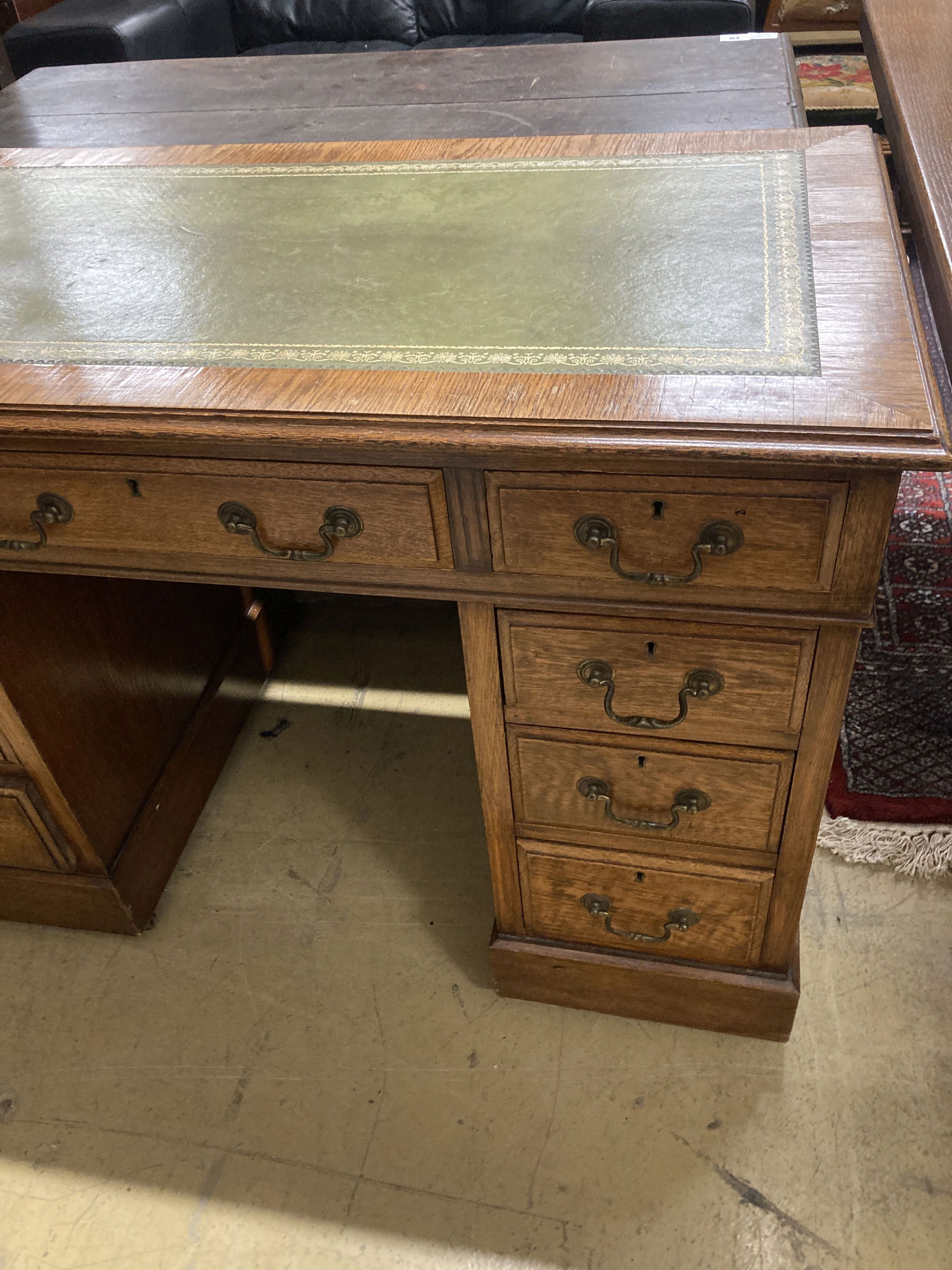 A small Victorian style oak pedestal desk, width 107cm, depth 57cm, height 76cm